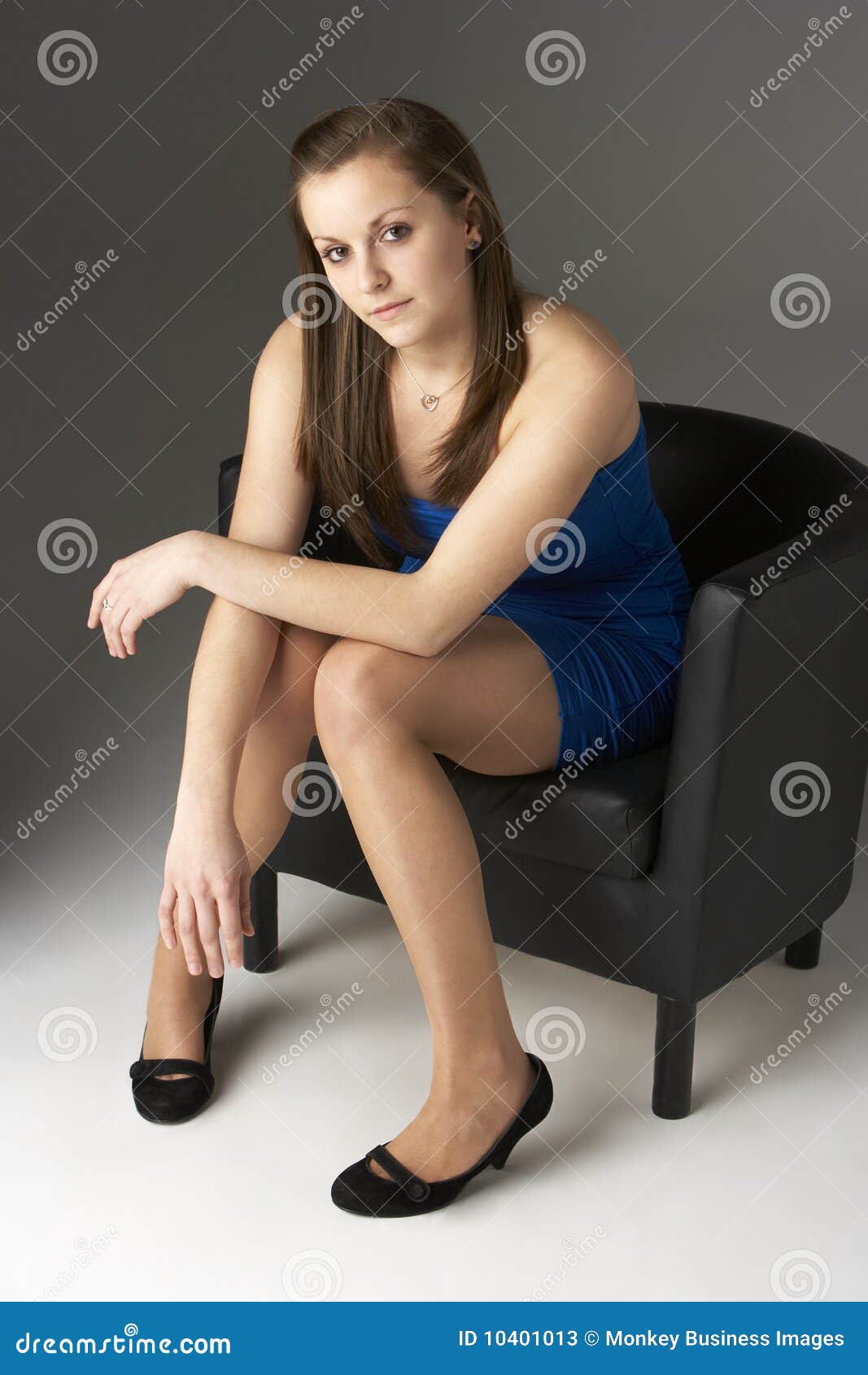 Sexy nude teen girl sitting on a chair